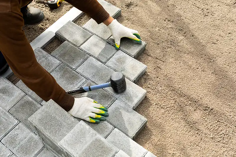 worker installing block paving